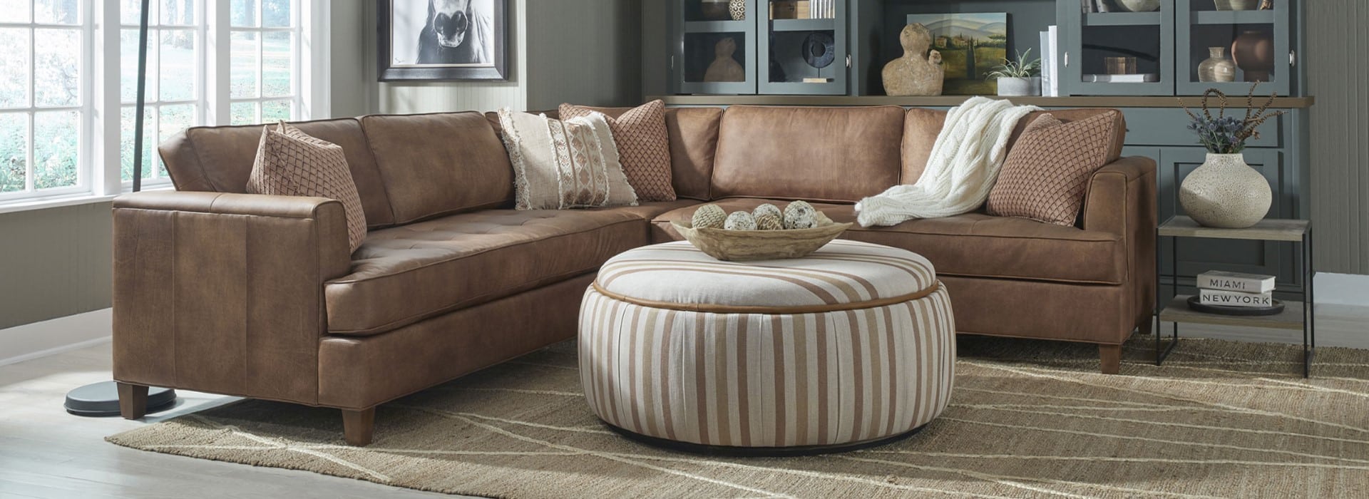Colton Section with Wilson Ottoman at By Design Furniture + Interior Design